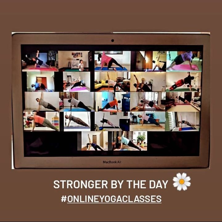 Students holding a pose together in an online class